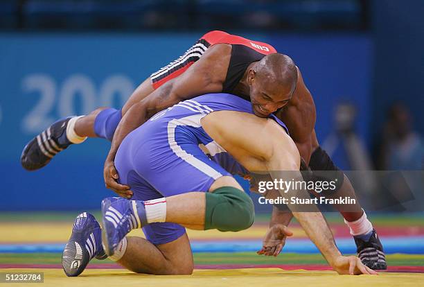 Yoel Romero of Cuba competes against Sazhid Sazhidov of Russia during the men's Freestyle wrestling 84 kg bronze medal match on August 28, 2004...