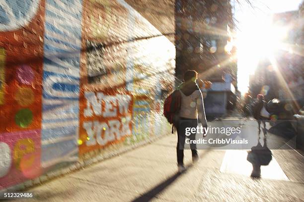 defocused image of sun rising down a nyc street - kid looking down stock pictures, royalty-free photos & images