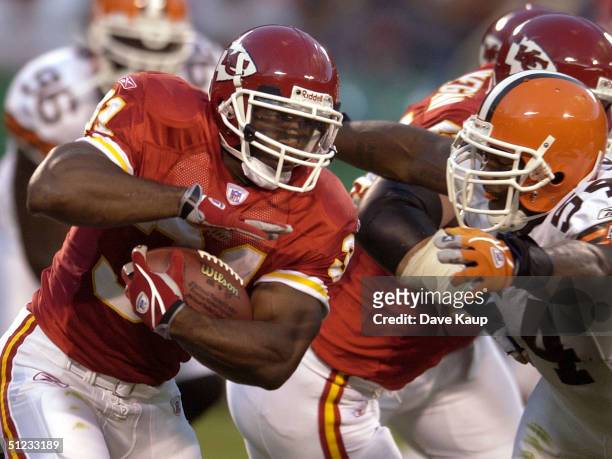 Running back Priest Holmes of the Kansas City Chiefs runs for a first down as Andra Davis the Cleveland Browns attempts to tackle August 28, 2004 in...