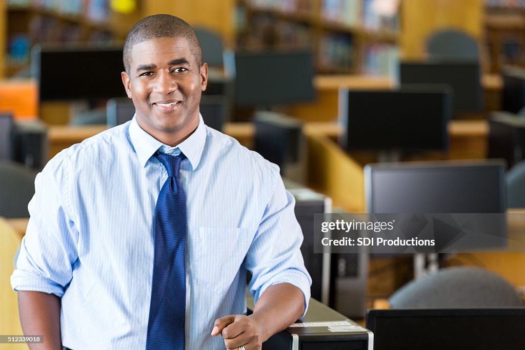 African American male teacher standing in computer lab