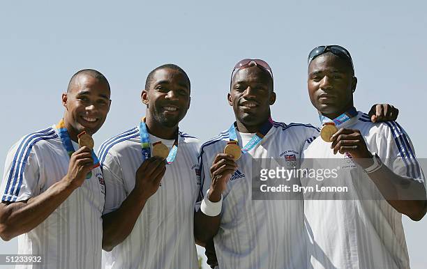 Olympic 4x100m relay Champions Jason Gardner, Darren Campbell, Marlon Devonish and Mark Lewis-Francis of Great Britain pose with their gold medals...