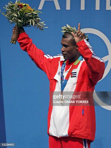 Gold medalist Mario Cesar Kindelam Mesa of Cuba celebrates on the podium during the Olympic Games awards ceremony of the lighweight boxing...