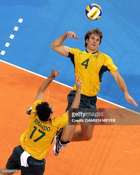 Brazilian Andre Heller spikes from a high pass by his teammate Ricardo Garcia during the gold medal volleyball match between Brazil and Italy at the...