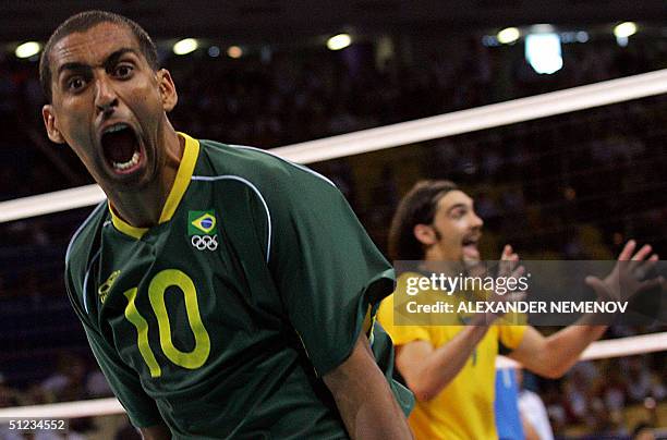 Brazilian Sergio Dutra Santos and his teammate Gilberto Godoy Filho celebrate their victory over Italy at the end of the gold medal volleyball match...