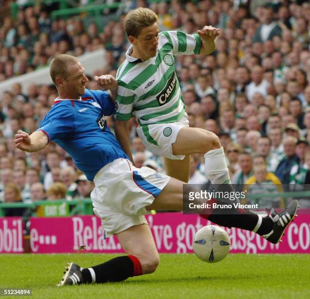 New Celtic signing Juninho of Celtic is challenged by Craig Moore during the Scottish premiership match at Celtic Park on August 29, 2004 in Glasgow,...