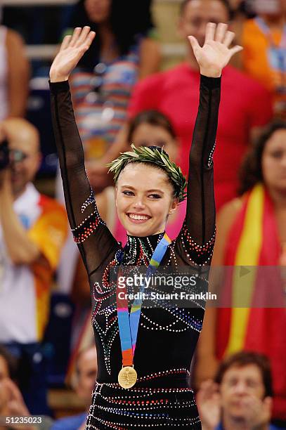 Gold medal winner Alina Kabaeva of Russia acknowledges her support during the medal ceremony for rhythmic gymnastics on August 29, 2004 during the...
