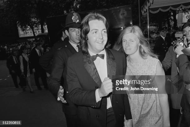 English musician, singer, and songwriter, Paul McCartney, and his wife American musician and photographer, Linda McCartney , arrive at the film...