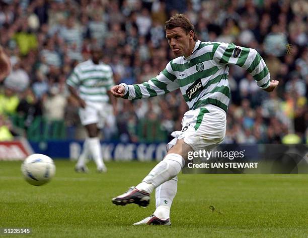 Celtic's Alan Thompson, slams the ball home into Rangers net for the winning goal late in the game 29 August 2004 in the Scottish Premier League...