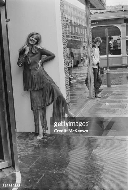 English actress and model, Vicki Hodge, wearing a fringed suede trouser suit designed by Ossie Clark, 15th May 1969.