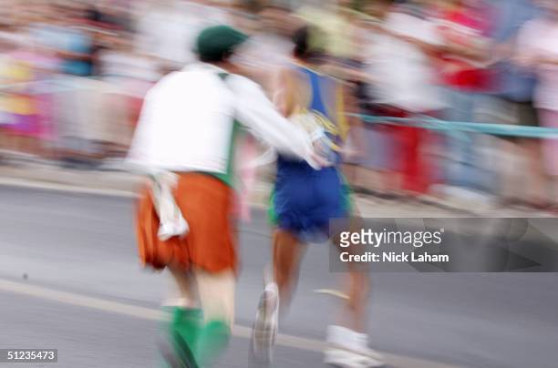 Cornelius Horan charges Vanderlei Lima of Brazil as he lead the race toward a crowd of spectators during the men's marathon on August 29, 2004 during...