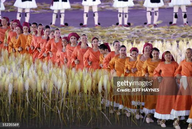 Dancers perform as traditional Greek harvesters through a spiral wheatfield made up of 45,000 individually 'planted' stalks at the Olympic Stadium 29...