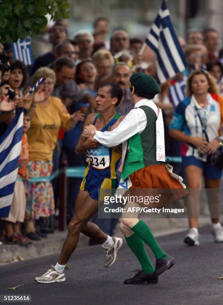 Vanderlei Lima of Brazil is attacked by Cornelius Horan a deranged Irish former priest in the latter stages of the marathon, the final event of the...