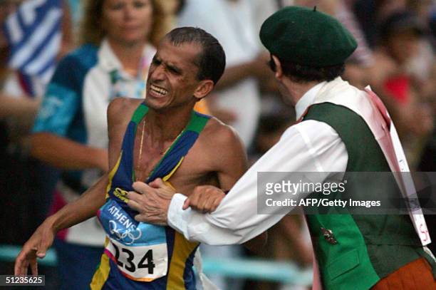 Vanderlei Lima of Brazil is attacked by Cornelius Horan a deranged Irish former priest in the latter stages of the marathon, the final event of the...