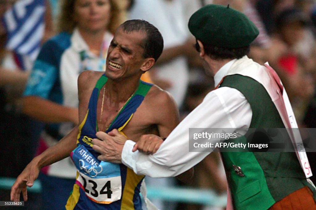 Vanderlei Lima of Brazil is attacked by...