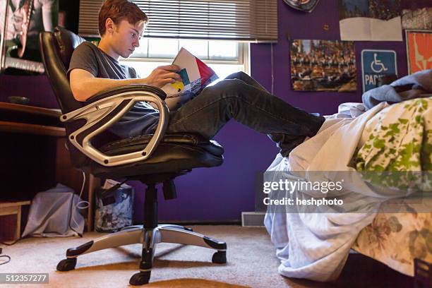 teenager reading magazine at home - teen bedroom poster stock pictures, royalty-free photos & images