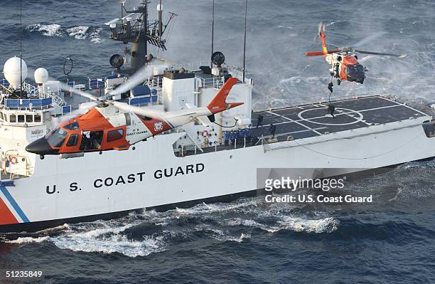 In this handout image provided by the U.S. Coast Guard, a Coast Guard maritime security force practices fast-roping to the Coast Guard cutter...