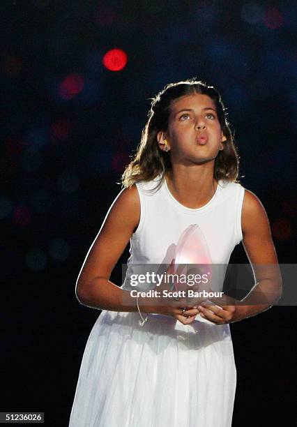 Fotini Papaleonidopoulou, 10 years-old, carries a lantern with the light taken from the cauldron flame during the closing ceremonies of the Athens...