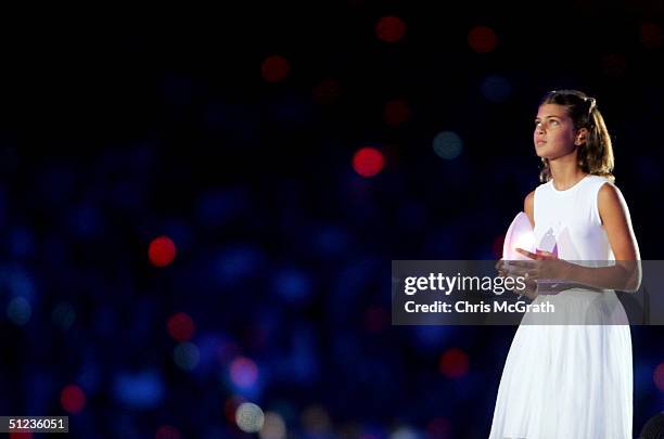 Fotini Papaleonidopoulou, 10 years-old, carries a lantern with the light taken from the cauldron flame during the closing ceremonies of the Athens...