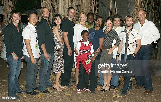 Cast members of ABC's new TV drama "Lost" pose before a banyan tree at the premiere of the show on Queen's Surf Beach in August 28, 2004 in Waikiki...