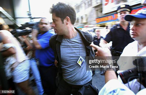 Newsday staff photographer Moises Saman is arrested during demonstrations outside Broadway shows running for Republican delegates in Times Square...