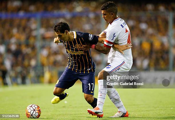 German Gustavo Herrera of Rosario Central fights for the ball with Diego Polenta of Nacional during a group stage match between Rosario Central and...