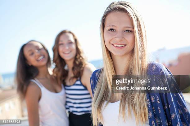 teenage girl, friends in background - the girl johanna stock-fotos und bilder