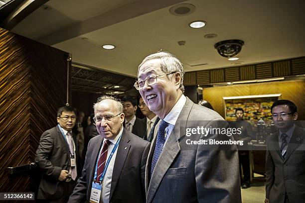 Zhou Xiaochuan, governor of the People's Bank of China , center, and Jacob Frenkel, chairman of JPMorgan Chase International, center left, arrives at...