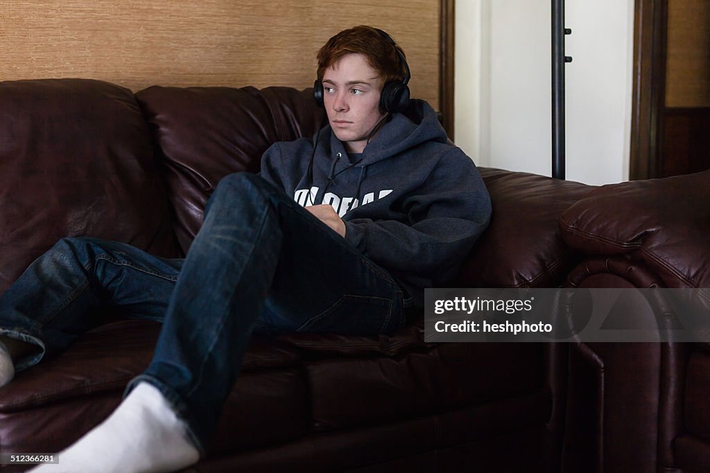 Teenager listening to music at home