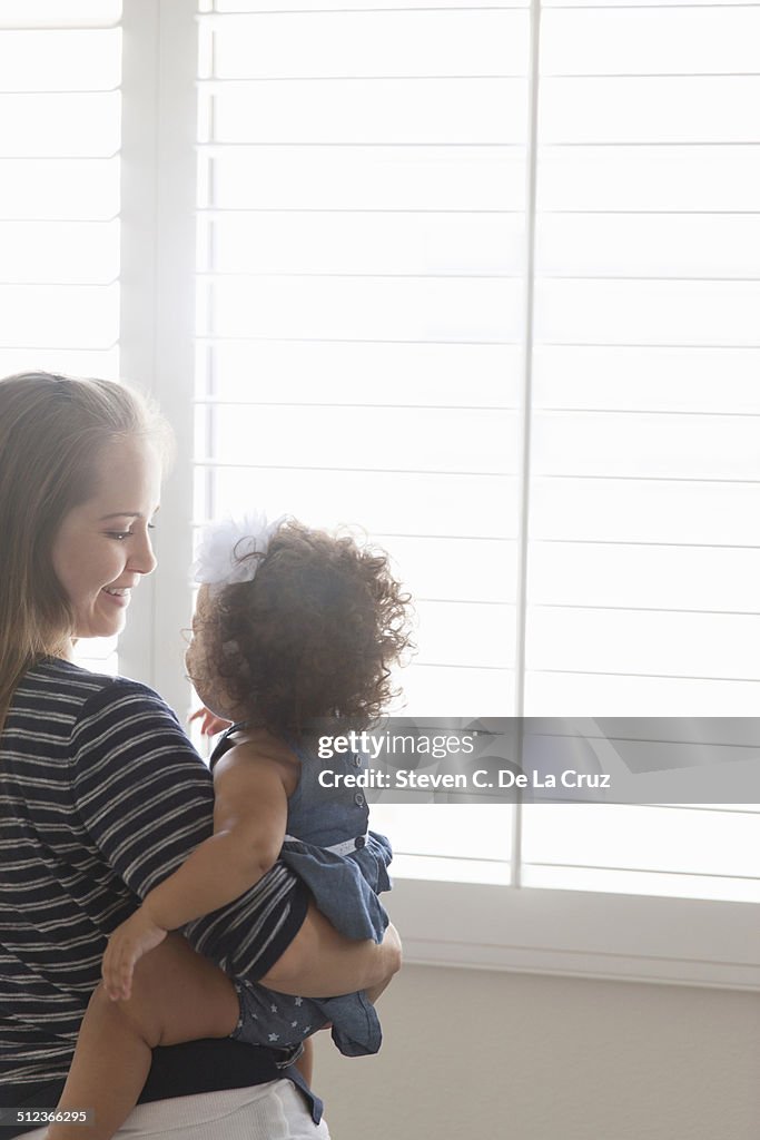 Mother holding baby daughter