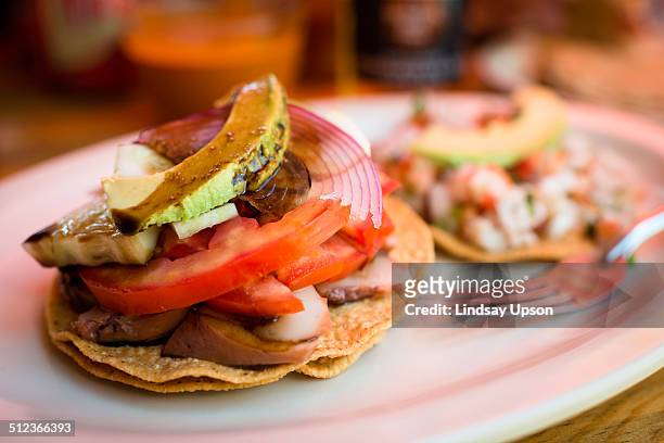 seafood (conch) tostada, close up - tostada stock pictures, royalty-free photos & images