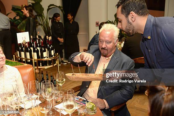 Guests enjoy a Dinner Hosted By Francis Mallmann And Paul Qui during 2016 Food Network & Cooking Channel South Beach Wine & Food Festival Presented...