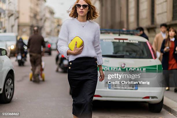 Candela Novembre wearing a white Fendi sweater, a yellow Stella McCartney clutch, a black Max Mara skirt seen outside Max Mara during Milan Fashion...