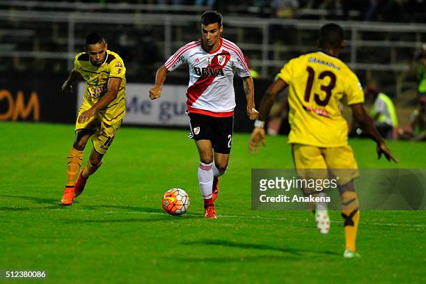 Enmanuel Manmana of River Plate struggles for the ball with Angel Nieves of Trujillanos during a group stage match between Trujillanos and River...