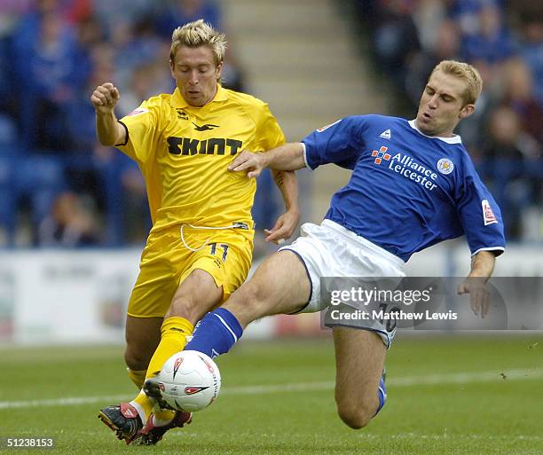 James Scowcrofyt of Leicester tackles Darren Currie of Brighton during the Coca-Cola Championship match between Leicester City and Brighton and Hove...