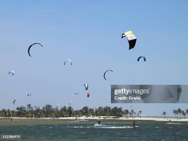 a group of people practicing kite surfing. - kite lagoon stock pictures, royalty-free photos & images