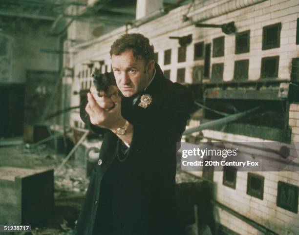 Gene Hackman as Detective Jimmy 'Popeye' Doyle points his handgun in a still from the film 'The French Connection' directed by William Friedkin.