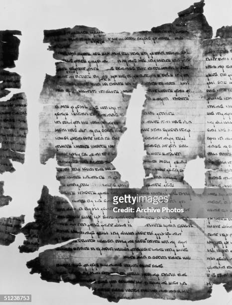 Torn portion of the Dead Sea Scrolls, one the major archaeological finds of the twentieth century discovered in 1947, concealed within jars in a...