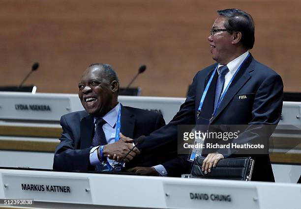 Acting President Issa Hayatou and FIFA Vice President David Chung of Papua New Guinea shake hands prior to the Extraordinary FIFA Congress at...