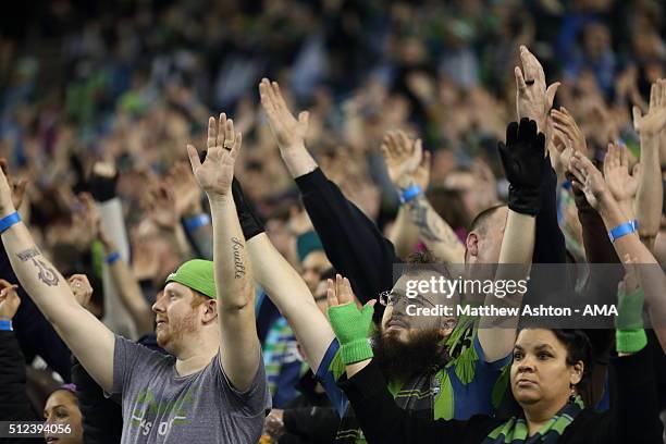 Fans of the Seattle Sounders hold up their hands during the CONCACAF Champions League match between Seattle Sounders and Club America at CenturyLink...