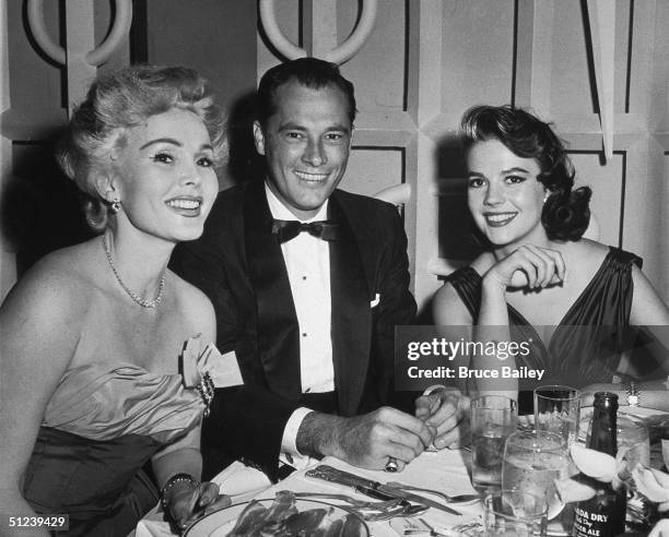 13th June 1957, Hungarian-born actor Zsa Zsa Gabor, hotel heir Conrad 'Nicky' Hilton , and American actor Natalie Wood at Mike Romanoff's Restaurant....
