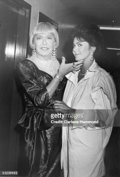 8th September 1985, American comedian Milton Berle wearing female drag while posing with American actor Lynda Carter backstage during the taping of...