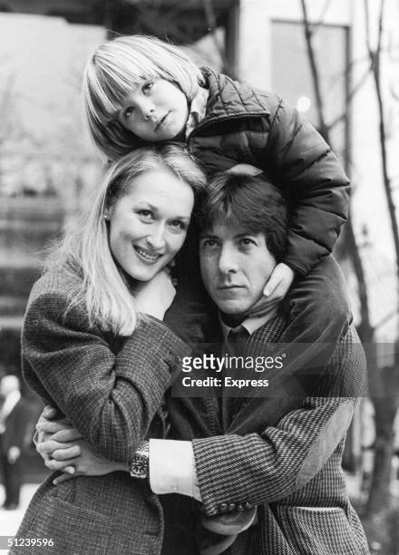 American actors Meryl Streep, Dustin Hoffman and Justin Henry embrace outdoors in the film 'Kramer vs Kramer', directed by Robert Benton.