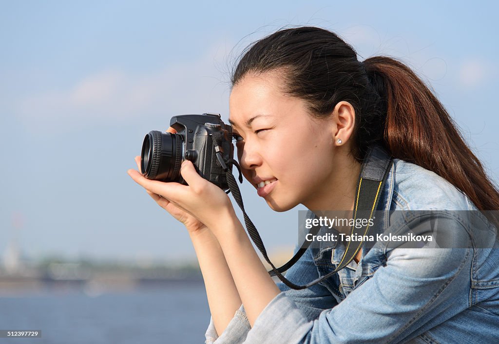 Female tourist taking pictures in city