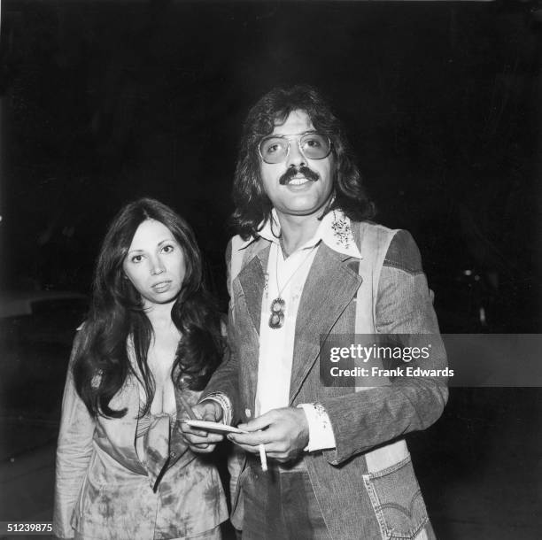 May 1974, American singer Tony Orlando smokes a cigarette while posing with his wife, Elaine, at a CBS party, Hollywood, California, May 1974. He is...