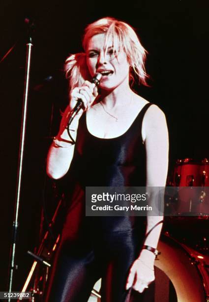 American singer and actor Debbie Harry performs in a black spandex unitard onstage with her group, Blondie, at Hammersmith Odeon, London, England.