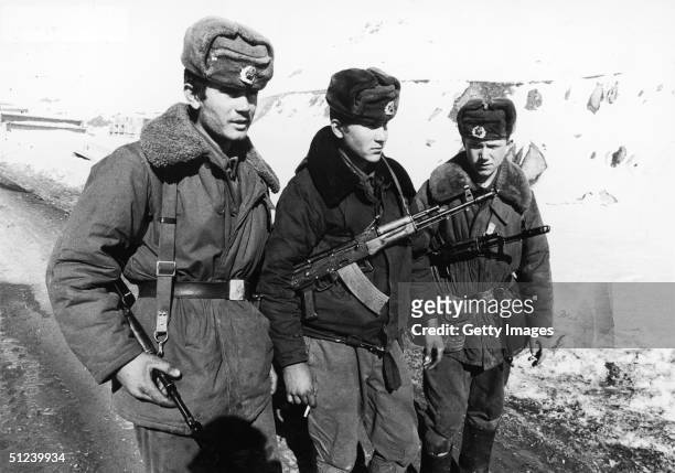 Three armed Soviet Army soldiers serving in the Afghan Civil War.