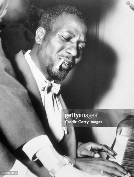 Circa 1955, American jazz pianist and composer Thelonious Monk smokes as he plays the piano 1950s.