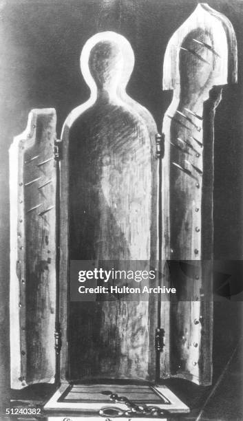 Circa 1500, The 'Jungfrau' or 'Iron Maiden' of Nurnberg, an instrument of torture. The insides of the cabinet are lined with spikes which pierce the...