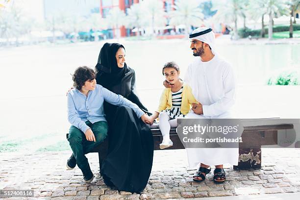arab family in the park - traditional clothing stock pictures, royalty-free photos & images
