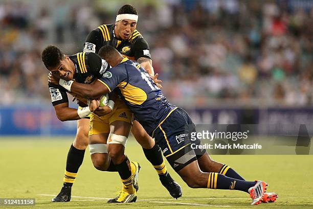 Ardie Savea of the Hurricanes is tackled by Tevita Kuridrani of the Brumbies during the round one Super Rugby match between the Brumbies and the...